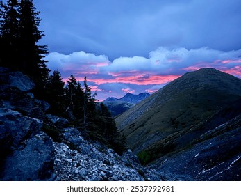 Majestic Mountain Sunset with Dramatic Pink and Purple Sky Over Rocky Landscape - Powered by Shutterstock