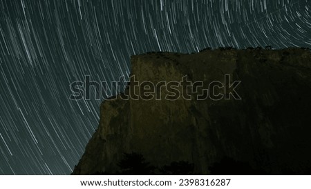 The Majestic Night Sky: A Breathtaking View of Stars Illuminating the Mountain Peaks