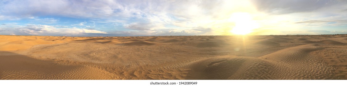 Majestic Panorama Of Landscape In The Sahara Desert, Tunisia. Sun With Bright Rays Over The Desert Horizon. Sand Dunes Against A Beautiful Sky