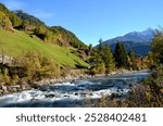 Majestic peaks rise above golden valleys, as crisp autumn air sweeps through the serene alpine landscape near Sölden in Tyrol, Austria