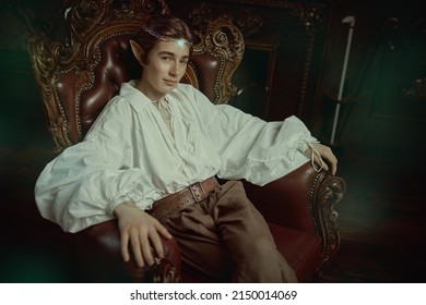 A Majestic Prince Of Elves Sitting In A Vintage Armchair In His Magic Castle. Fantasy. Fairy Tale, Magic. 