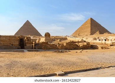Majestic pyramids of Giza under a clear blue sky in the afternoon sun