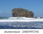 Majestic sentinel: A towering searock at Indrayanti Beach, Yogyakarta