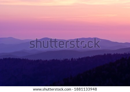 A majestic shot of impressive layered mountain range in Great Smoky Mountains National Park at purple sunset