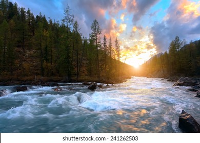 Majestic Sunset Against A Mountain Landscape. And Rough River Of Mount Altai, Russia