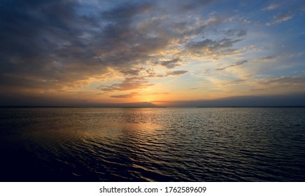 Majestic Sunset Clouds In Sky Over Sea Water