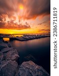 A majestic sunset over Lake Mendota with boats in the foreground in Madison, Wisconsin