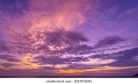 Majestic sunset or sunrise landscape Amazing light of nature cloudscape sky and Clouds moving away rolling colorful dark sunset clouds with reflection in water sea surface Amazing view