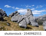 Majestic View of Castle Hill Rocks on a Sunny Day with Impressive Boulder Formations and Rolling Hills of Grass, Canterbury, New Zealand