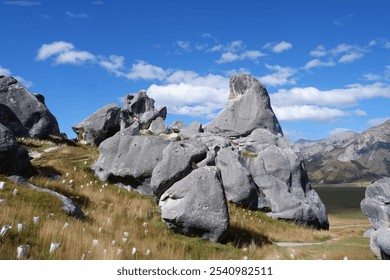 Majestic View of Castle Hill Rocks on a Sunny Day with Impressive Boulder Formations and Rolling Hills of Grass, Canterbury, New Zealand - Powered by Shutterstock