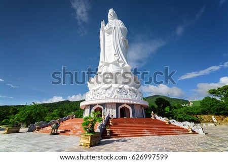 Majestic view of the Lady Buddha (the Bodhisattva of Mercy) at the Linh Ung Pagoda, Danang (Da Nang), Vietnam. White Buddha statue on blue sky background.