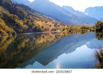 Majestic view of the mountains reflected in the lake in the morning haze. Merging with nature, environmental friendliness, ecology. Abstract natural background. Wallpaper. - Shutterstock ID 2215136817