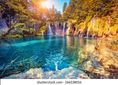 Majestic view on turquoise water and sunny beams in the Plitvice Lakes National Park. Croatia. Europe. Dramatic unusual scene. Beauty world. Retro filter and vintage style. Instagram toning effect. - Shutterstock ID 266538056