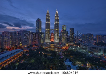 Majestic view of Petronas Twin Towers during blue hour sunset with dramatic sky. Petronas Twin Towers is the tallest building in Malaysia.