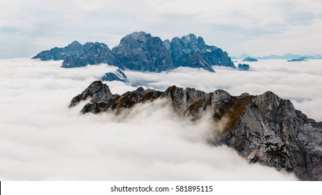 Majestic view of Triglav mountains in the clouds. Captured from Mangart mountain, located etween Italy and Slovenia.