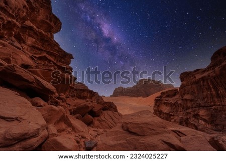 Majestic view of the Wadi Rum desert, Jordan, The Valley of the Moon. Orange sand, Milky Way sky. Copy space night wallpaper. Discover beauty of the earth. National park outdoors landscape