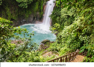 Majestic waterfall in the rainforest jungle of Costa Rica. Tropical hike. - Shutterstock ID 1076498693