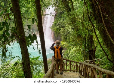 Majestic waterfall in the rainforest jungle of Costa Rica. Tropical hike. - Shutterstock ID 1986843596