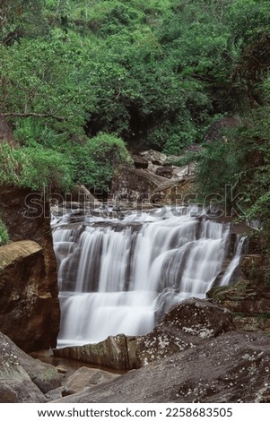 Majestic waterfall Ramboda symbol of Sri Lanka -  rocky mountain- long exposure photograph