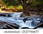 Majestic waterfalls at Porcupine Mountains Wilderness State Park, Michigan, cascading through lush forests and rugged terrain. Perfect for nature enthusiasts and landscape photography lovers.