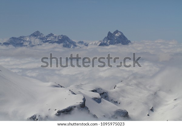 Majestical scene with ice mountains with snowy\
peaks middle of clouds, Landscape with beautiful high rocks and\
dramatic cloudy sky in clear blue bright day, Nature backgrounds,\
Vintage travel\
destinat