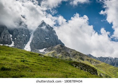 Majestical scene with mountains peaks in clouds in Georgia