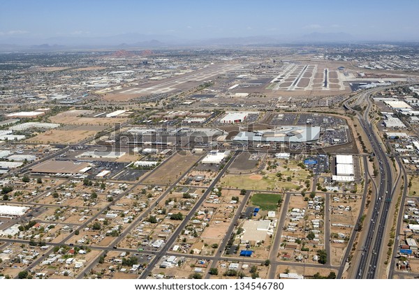 Major international airport aerial\
view with rental car center and Interstate 10\
access