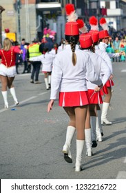 majorettes with white and red uniforms perform in the streets of the city. photographic series 