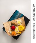 A makar sankranti elements like Tilgul, kumkum and black saari. A Sankranti festive objects and ingredients.