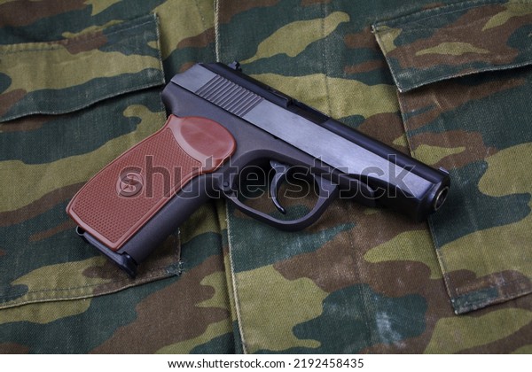 The Makarov-Walther pistol or PM (Pistolet\
Makarova, lit. Makarov\'s Pistol) is a Soviet semi-automatic pistol\
stolen from german Walther PP pistol on russian army camouflage\
uniform background.