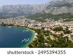 Makarska, Croatia. Coastal town, sea and mountains, Biokovo park. Aerial photography from a drone. Croatian town on the Adriatic Sea. Makarska Riviera