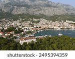 Makarska, Croatia. Coastal town, sea and mountains, Biokovo park. Aerial photography from a drone. Croatian town on the Adriatic Sea. Makarska Riviera