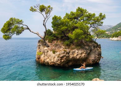 Makarska, Croatia - September 6, 2019: Unidentified Woman Riding Sea Kayak Near Croatian Coast Of Adriatic Sea In Makarska Riviera, Dalmatia, Croatia.