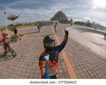 MAKASSAR, INDONESIA - JULY 15 2020: Selfie Uses A Go Pro In Front Of The 99 Dome Mosque At Losari Makassar Beach