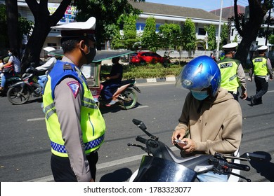 MAKASSAR, INDONESIA - JULY 25 2020: The traffic police are checking motorcycle riders on the streets