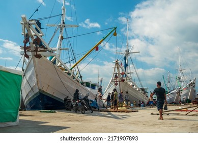 Makassar, Indonesia - June 21 2022 : people activities at Paotere Port, the heritage port of the Gowa Tallo Sultanate, which is located in Ujung Tanah District, Makassar, South Sulawesi.