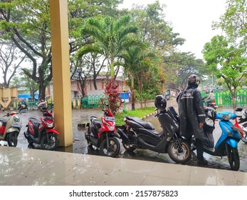 Makassar, Indonesia - May 19, 2022: Motorcyclists Shelter In The Rain.