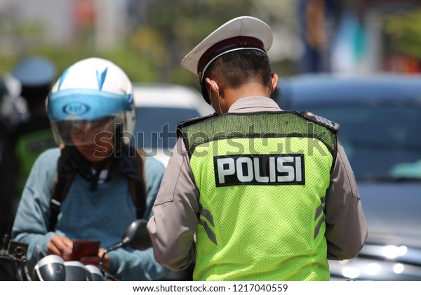 MAKASSAR, INDONESIA - OCTOBER 31 2018: Vehicle\
inspections carried out by police officers against a number of\
vehicles in the city of Makassar. Inspections in the context of\
zebra operation