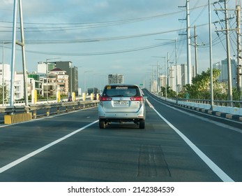 Makati, Metro Manila, Philippines - April 2022: Driving through the northbound lane of Skyway. Tailing a gray minivan.