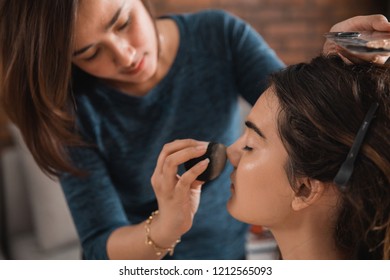 Make Up Artist Applying Foundation With A Beauty Blender