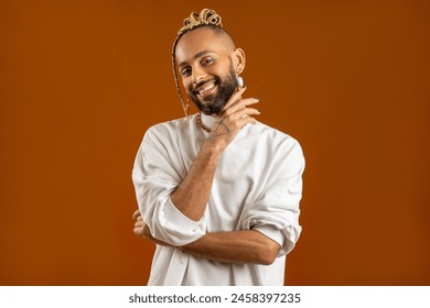 Make up artist. Black african american gay man with bright make-up in white clothes smiling looking at camera isolated on orange background studio portrait Fashion makeup lgbt concept. - Powered by Shutterstock