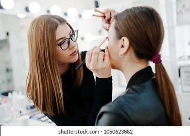 Make up artist work in her beauty visage studio salon. Woman applying by professional make up master. Beauty club concept. - Shutterstock ID 1050623882