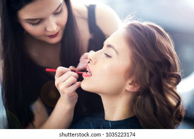 Make up artist working on client