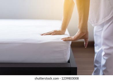 Make a bed,Woman making her bed in room after wake up - Shutterstock ID 1239803008