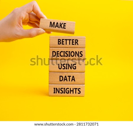 Make better decisions using data insights symbol. Concept words make better decisions using data insights on wooden blocks. Businessman hand. Beautiful yellow background. Business concept. Copy space.