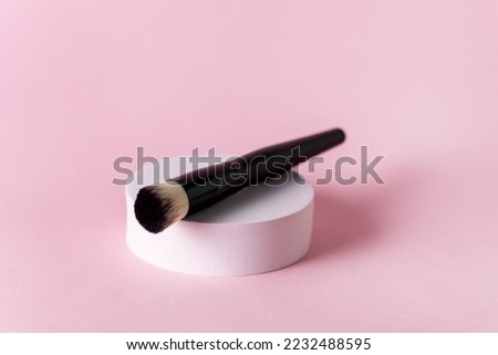 Make up Brush on White Round Pedestal Pink Background Minimal Make Up Concept Horizontal