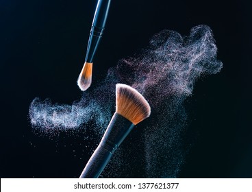 Make Up Brush With  Powder Explosion On Black Background.