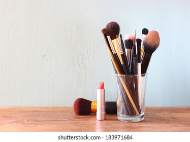 Make Up Brushes Over Wooden Table 