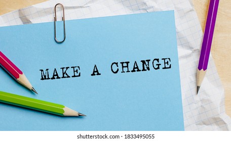 Make A Change text written on a paper with pencils in office