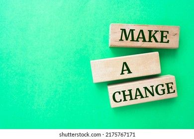 Make A Change Words On Wooden Blocks On Green Background.